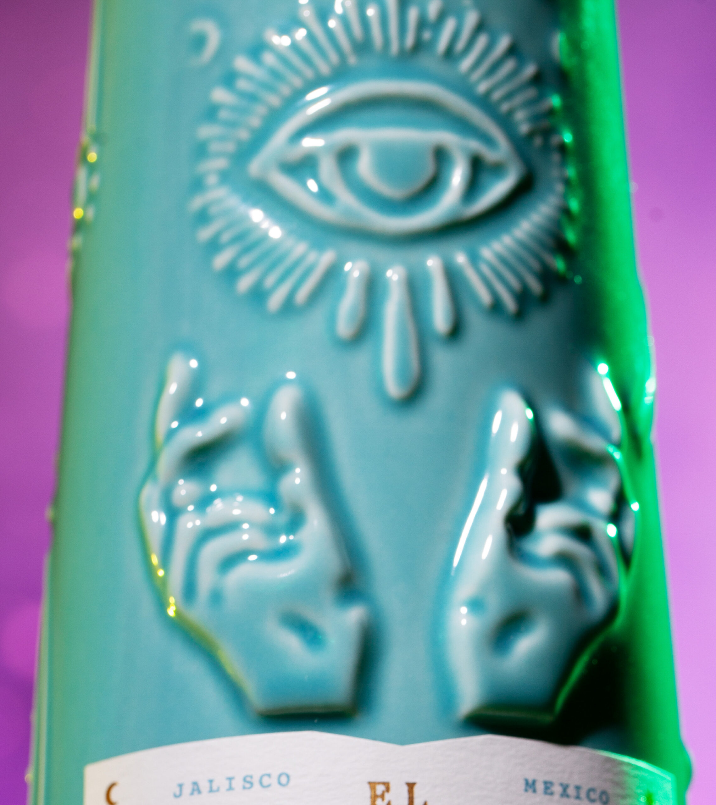 Close up shot of El Mágico Tequila Blanco flavor bottle embossed details.