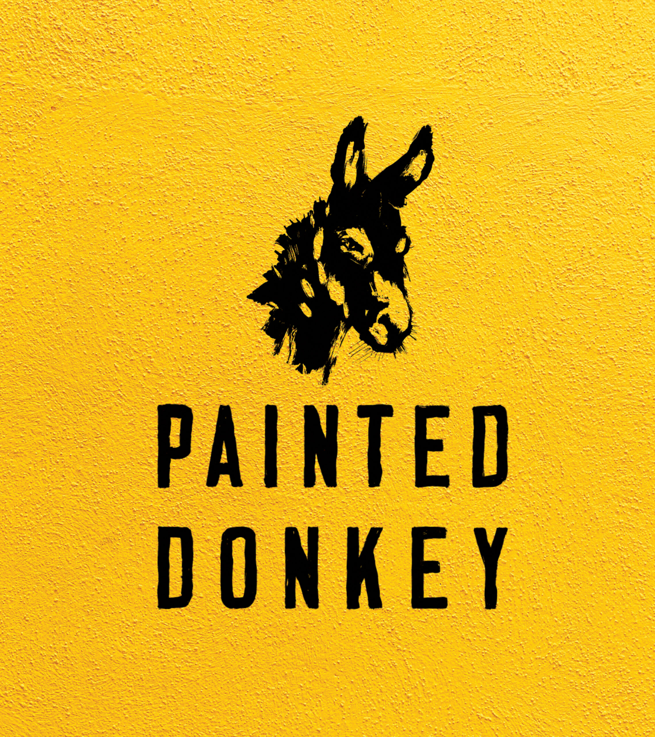 Painted Donkey logo over yellow wall background