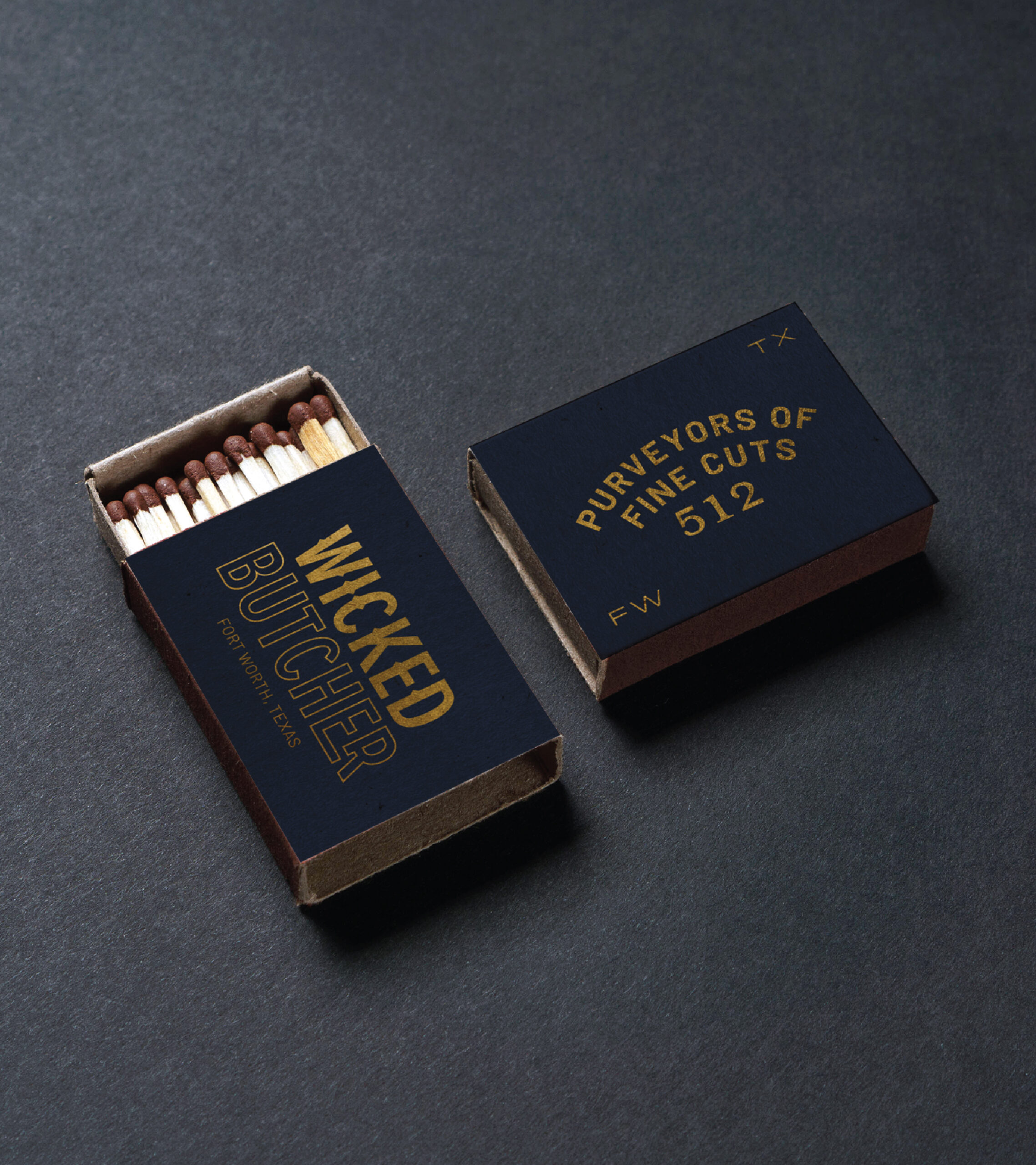 Wicked Butcher branded match boxes against a dark gray background